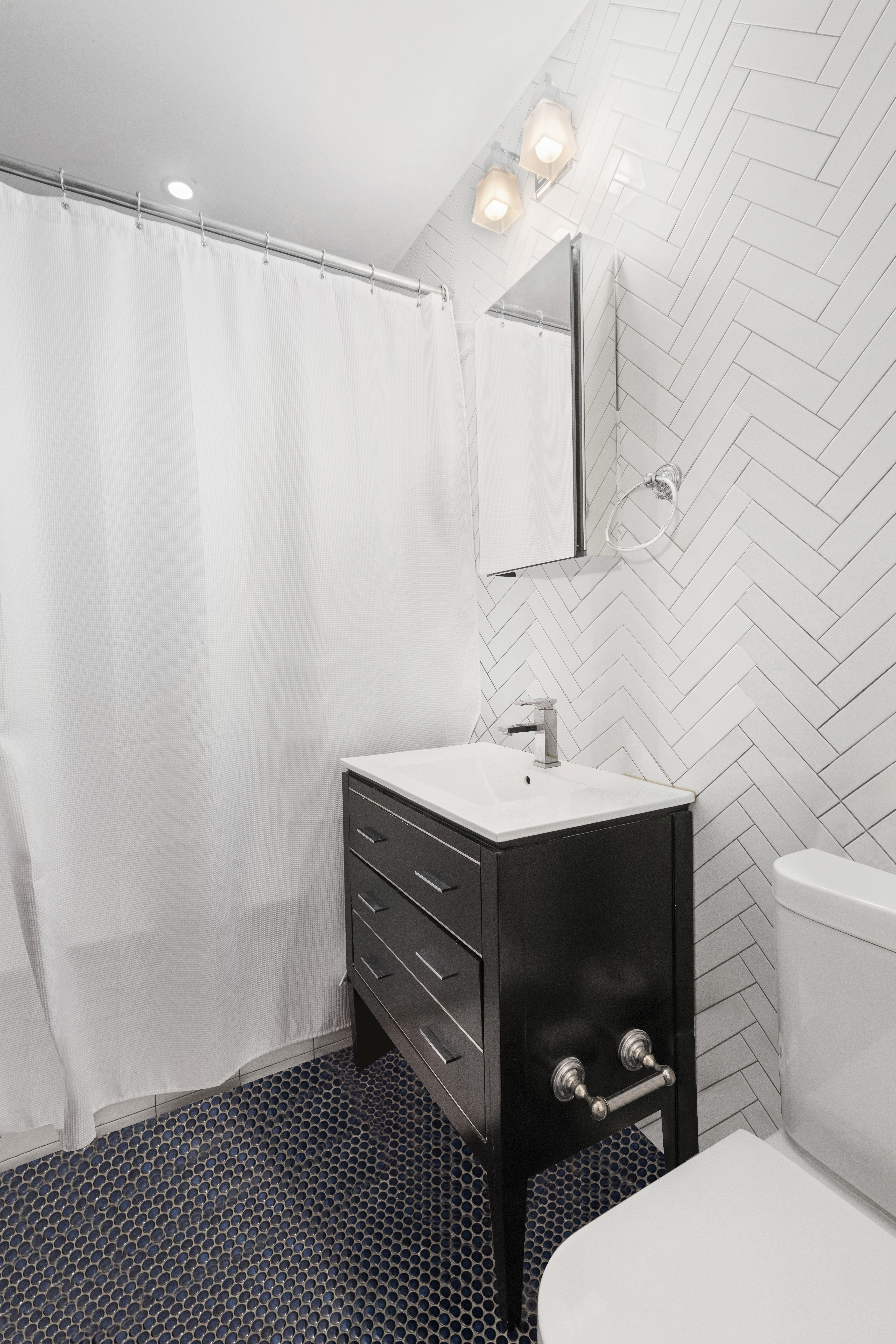 170 West 83rd Street, Unit 2W Manhattan, NY 10024 - Photo 9 of 10 a bathroom with a sink and a mirror