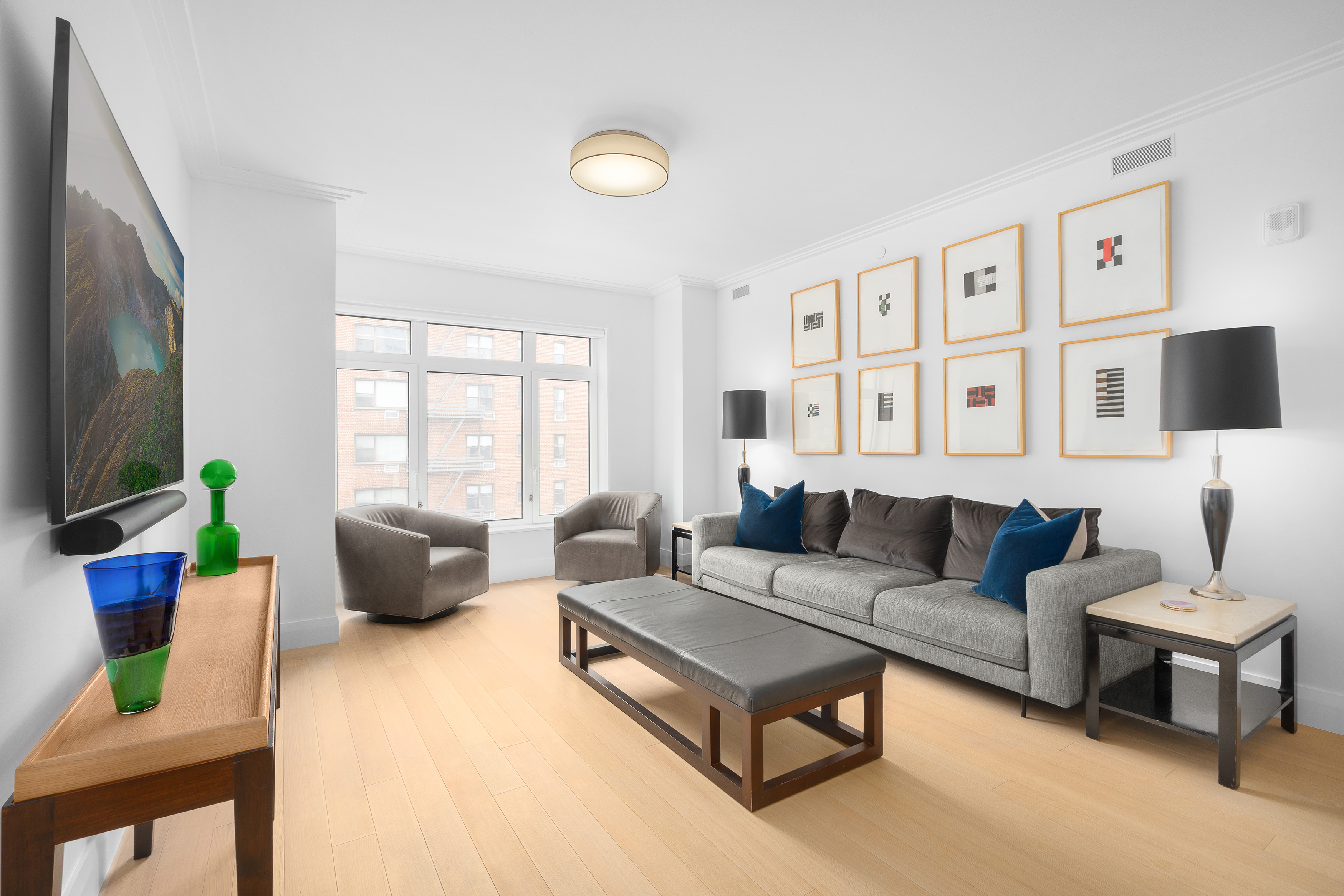200 East 83rd Street, Unit 5D Manhattan, NY 10028 - Photo 3 of 29 a living room with furniture and a flat screen tv