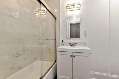 a bathroom with a bathtub and a sink