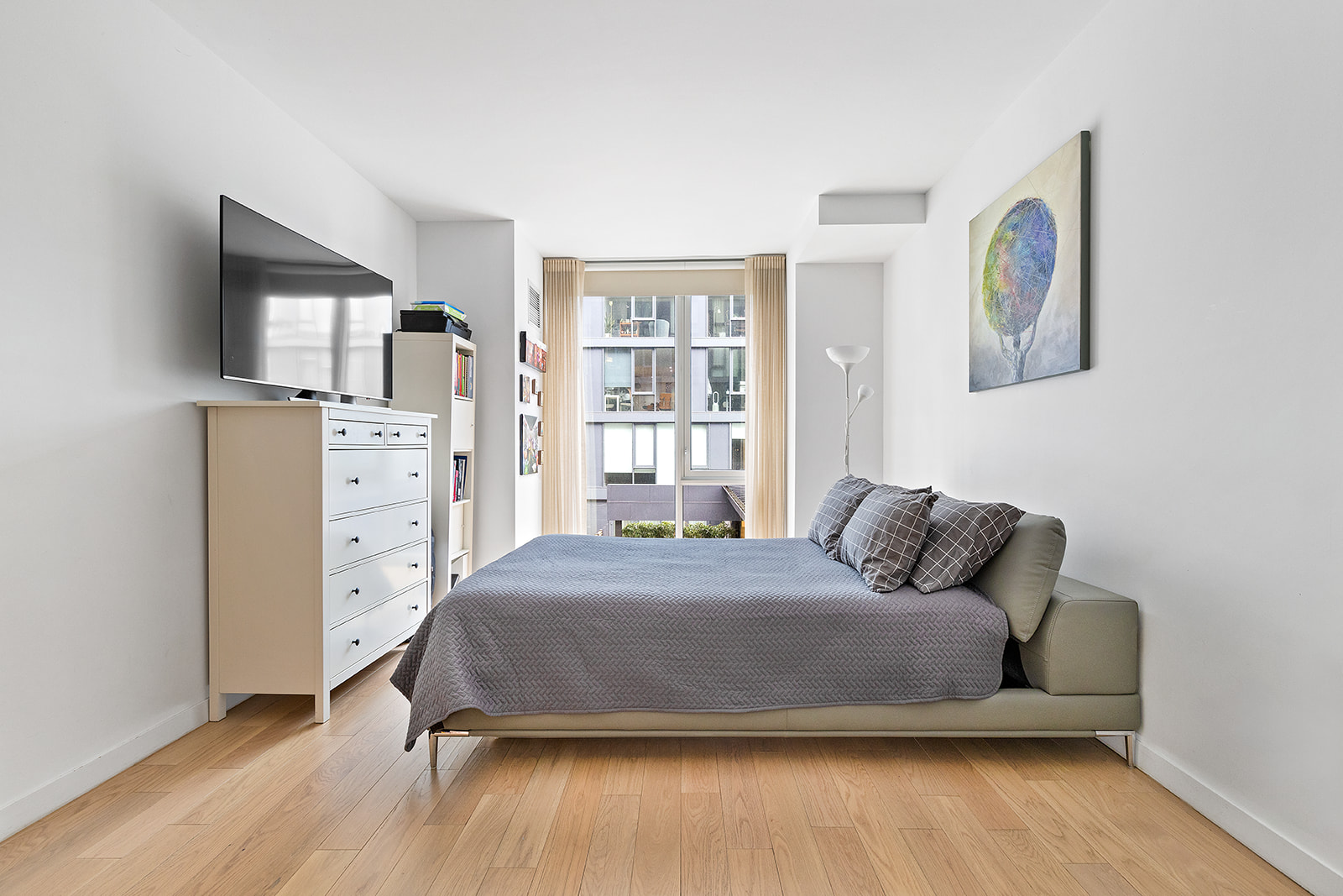 540 West 49th Street, Unit 108N Manhattan, NY 10019 - Photo 3 of 9 a bedroom with a bed and a window