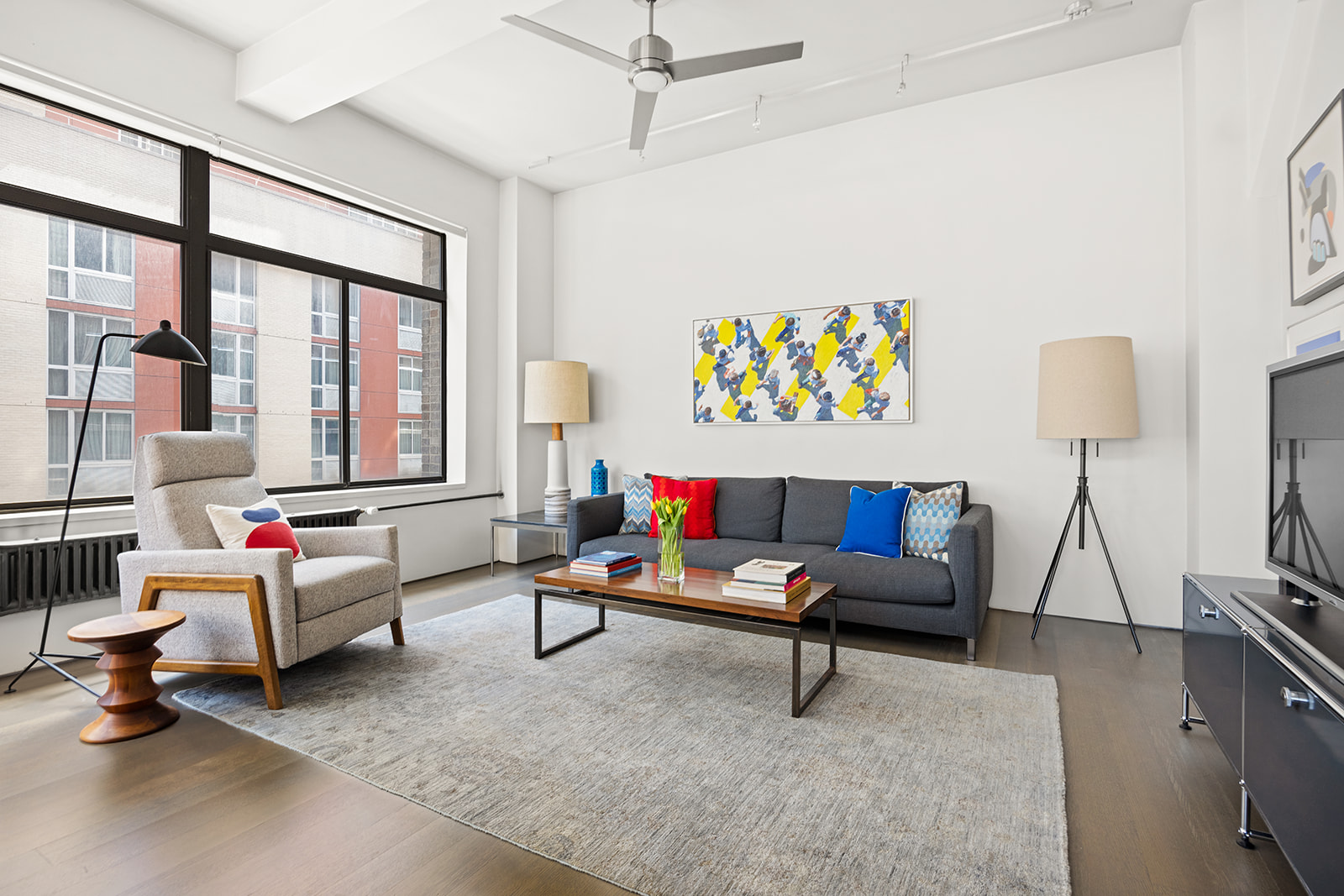 348 West 36th Street, Unit 6N Manhattan, NY 10018 - Photo 1 of 12 a living room with furniture and a flat screen tv
