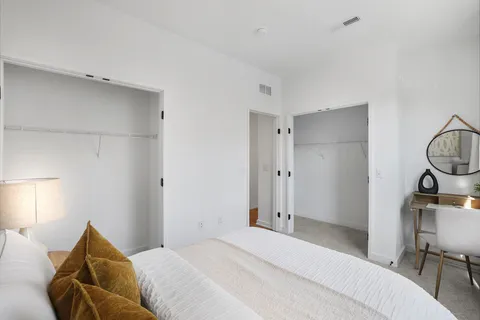 a bedroom with a bed and chair