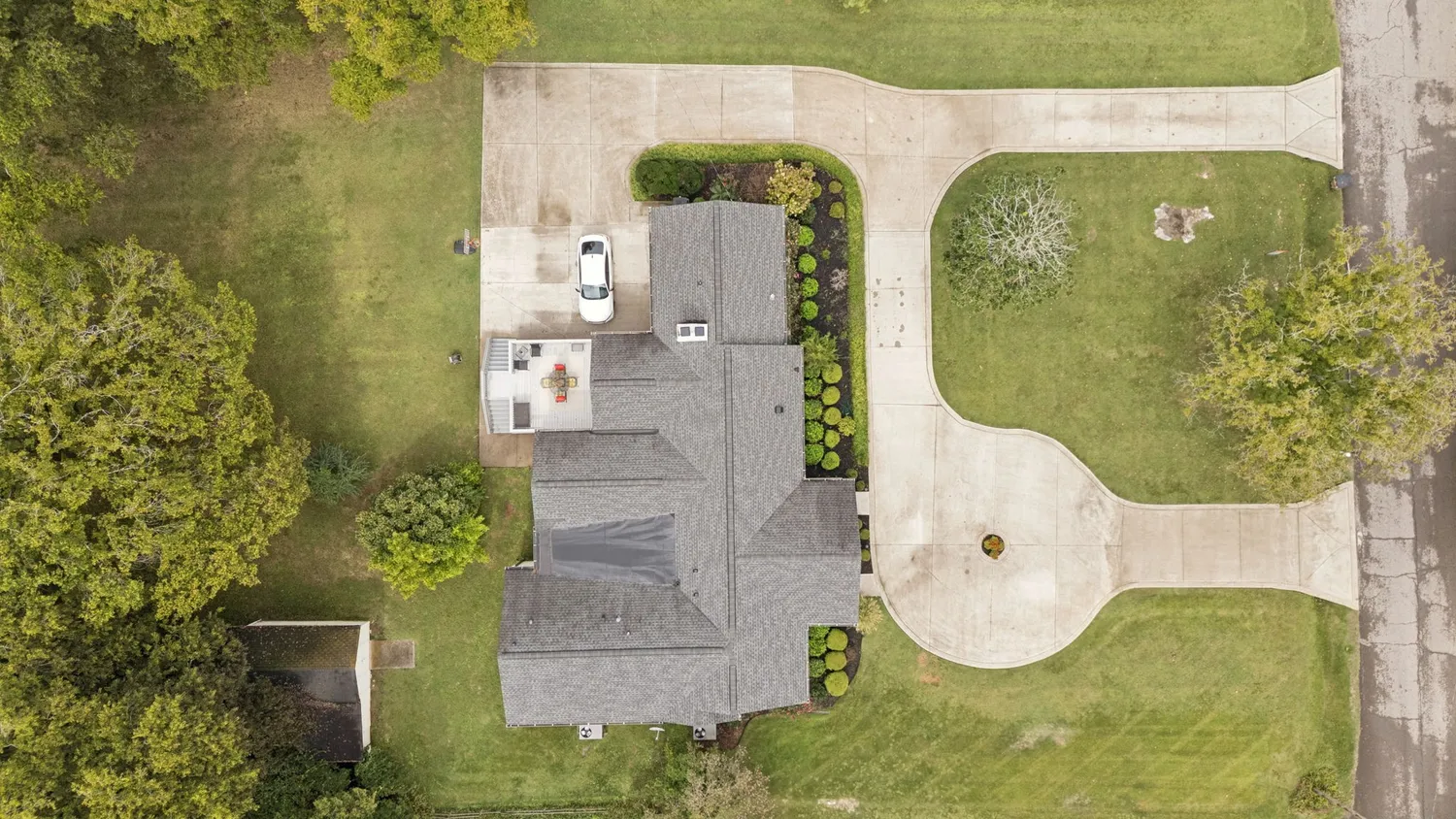a aerial view of a residential houses with yard