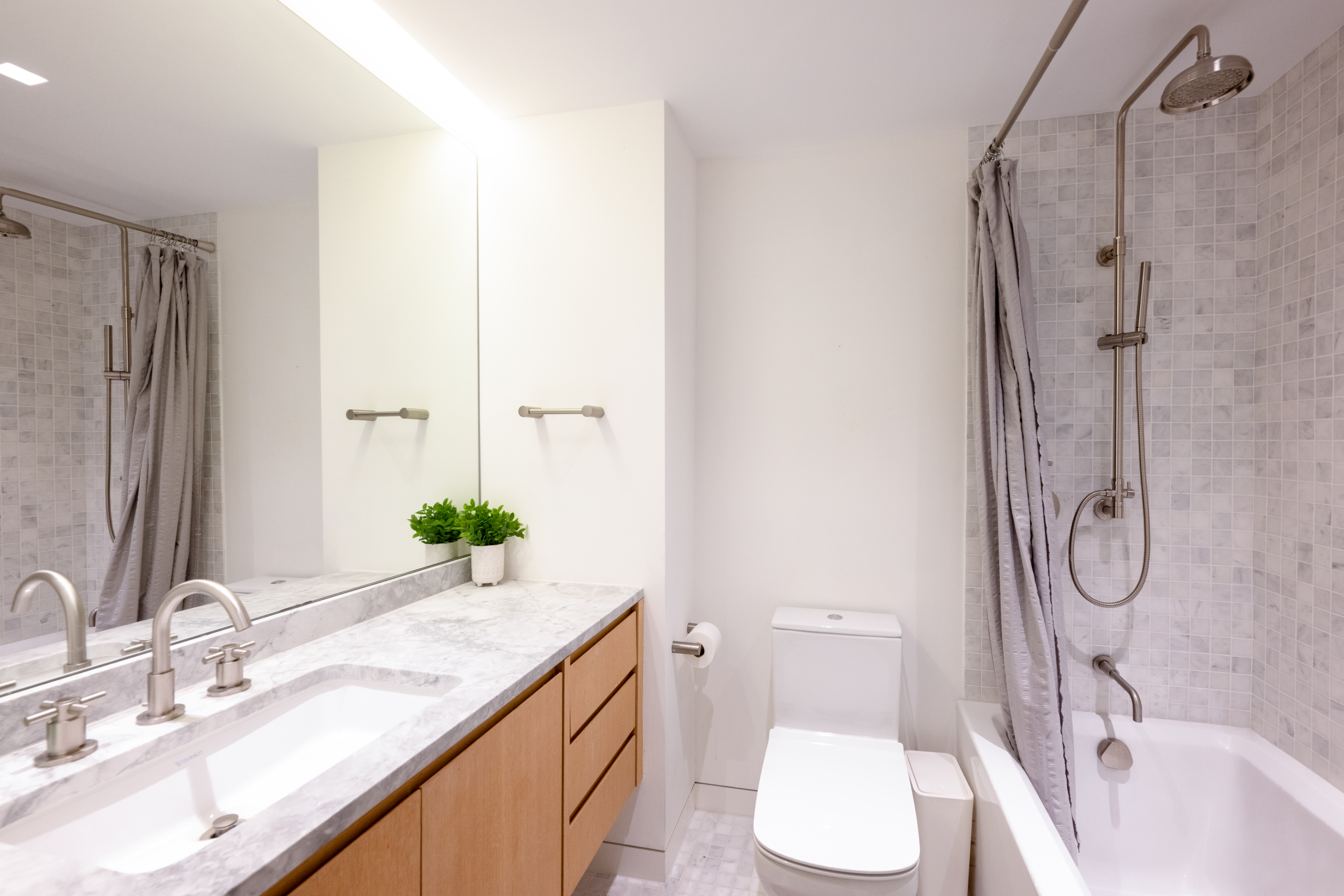 124 East 79th Street, Unit 7D Manhattan, NY 10075 - Photo 12 of 25 a bathroom with a granite countertop sink toilet and shower