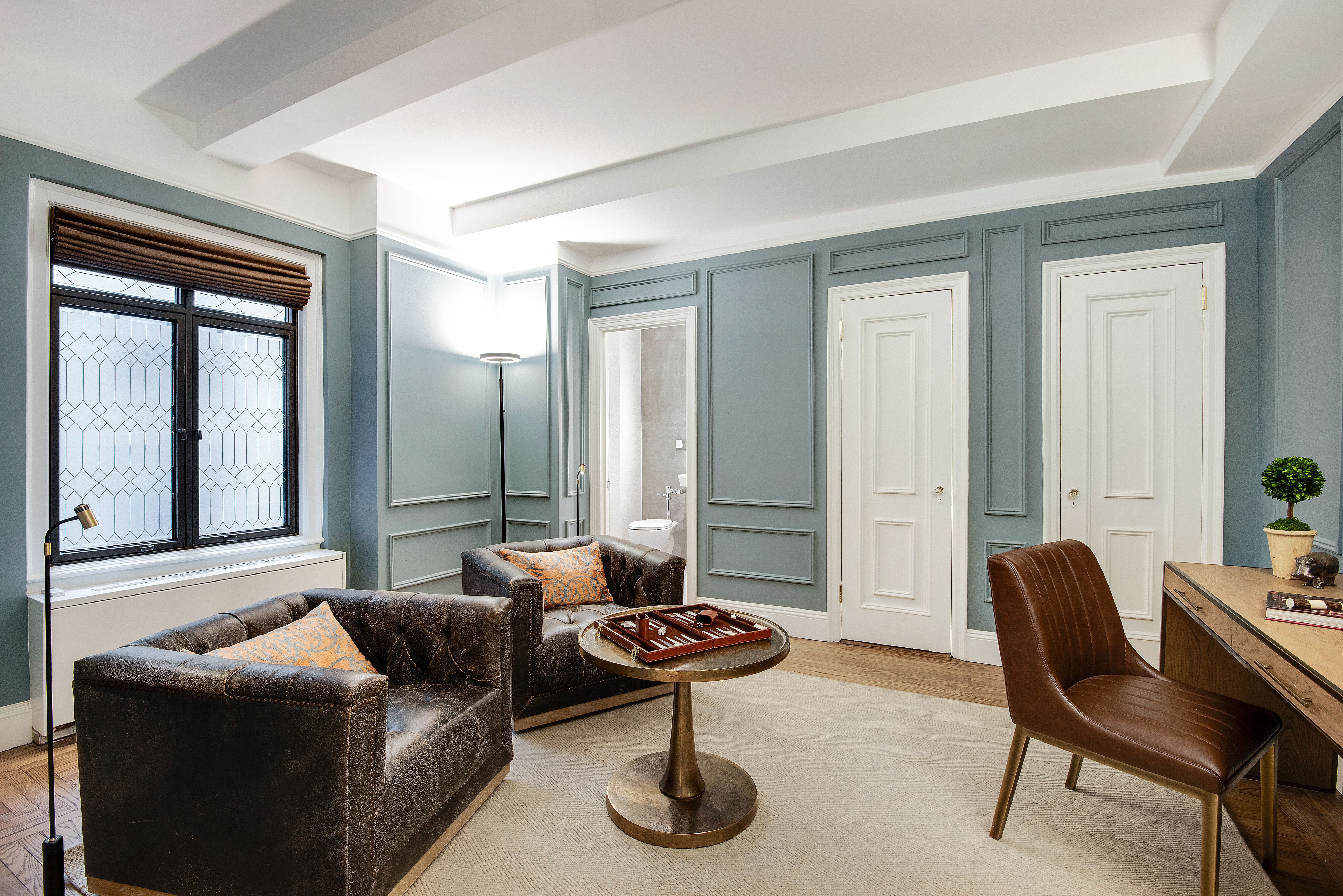 439 East 51st Street, Unit 8A Manhattan, NY 10022 - Photo 10 of 13 a living room with furniture and a large window