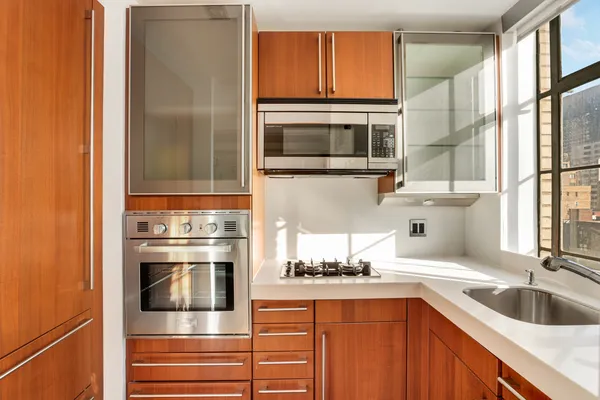 a kitchen with stainless steel appliances granite countertop a refrigerator and a sink