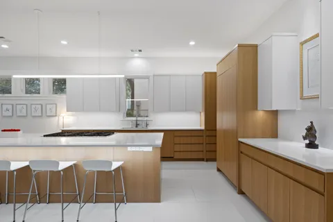 a kitchen with stainless steel appliances kitchen island granite countertop a sink and cabinets
