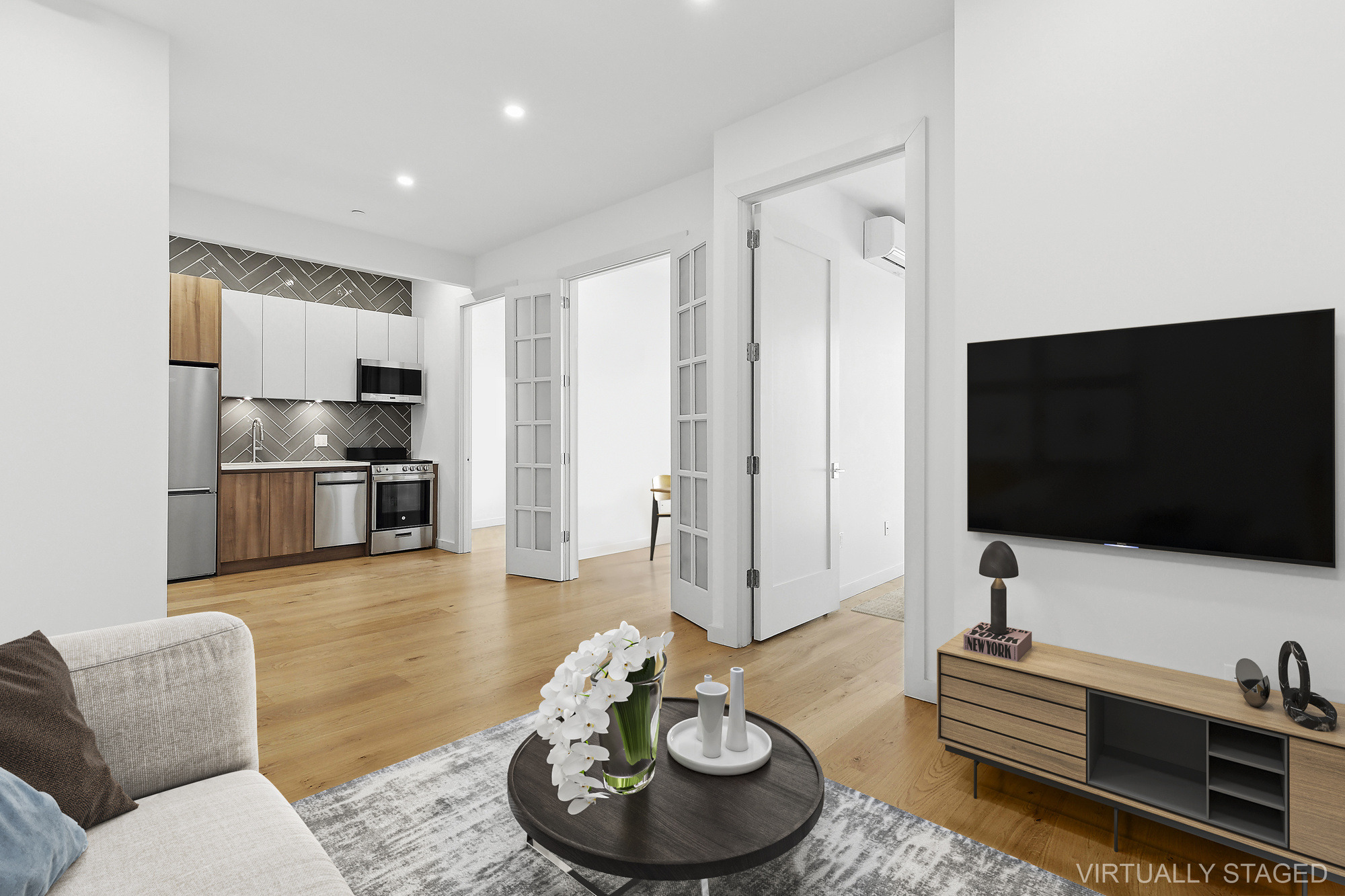 138 Schaefer Street, Unit 3A Brooklyn, NY 11207 - Photo 1 of 12 a living room with furniture and a flat screen tv