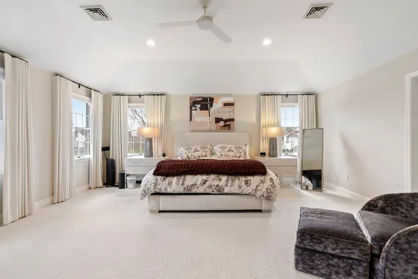 a white bath tub sitting in a bathroom next to a window