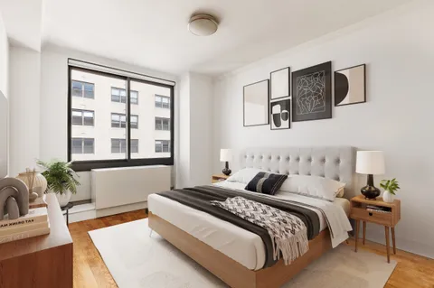 a bedroom with bed and a potted plant