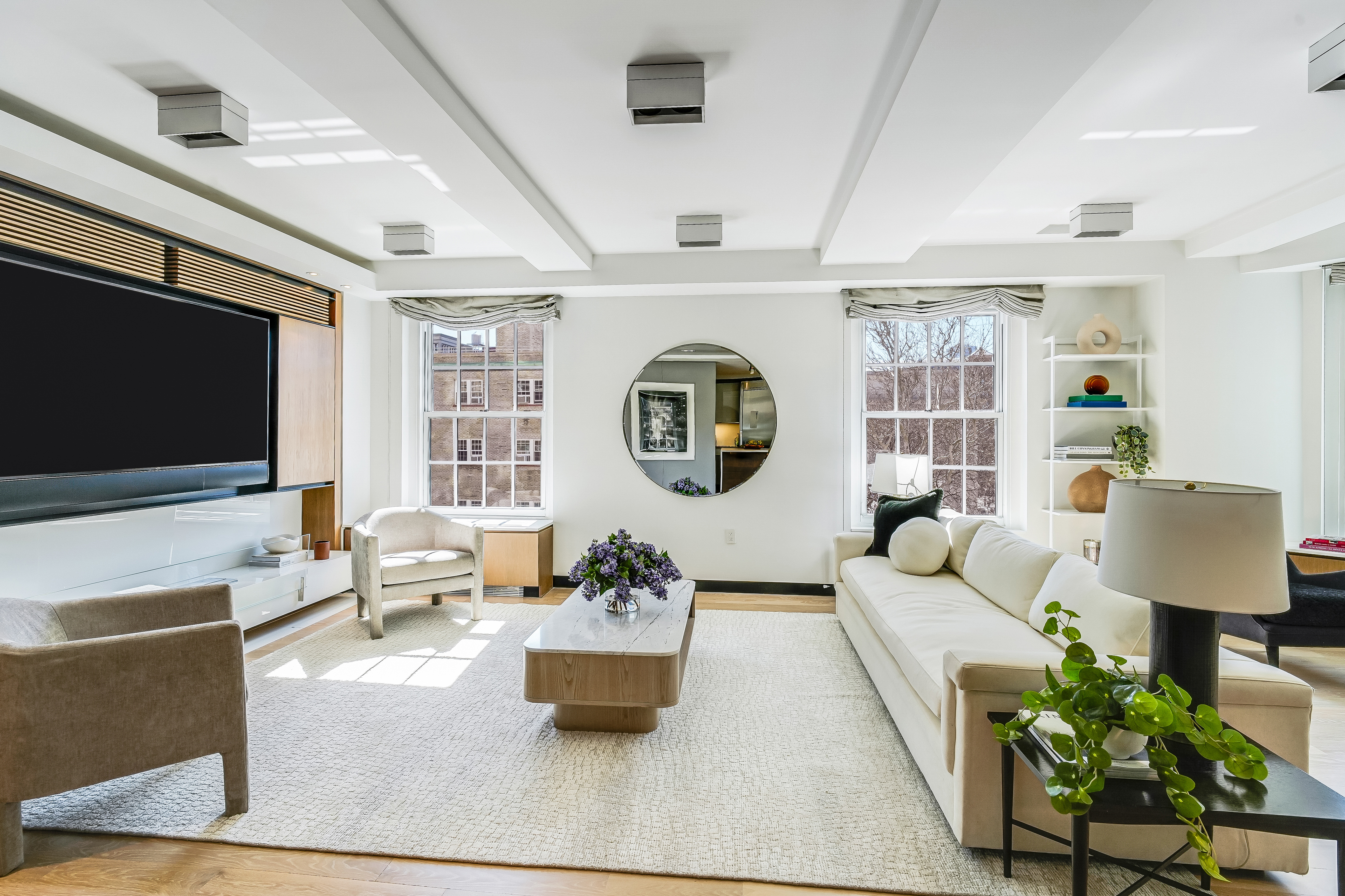 1 5th Avenue, Unit 5GH Manhattan, NY 10003 - Photo 3 of 26 a living room with furniture and a flat screen tv