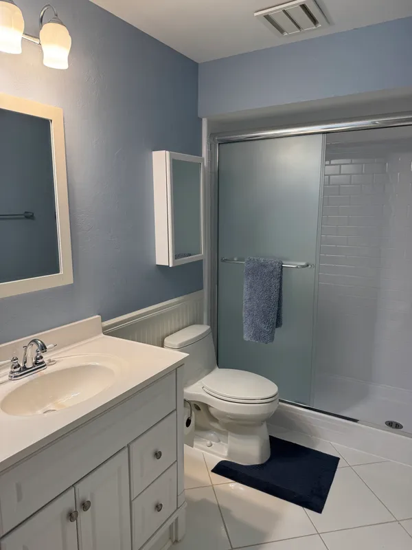 a bathroom with a sink toilet and shower