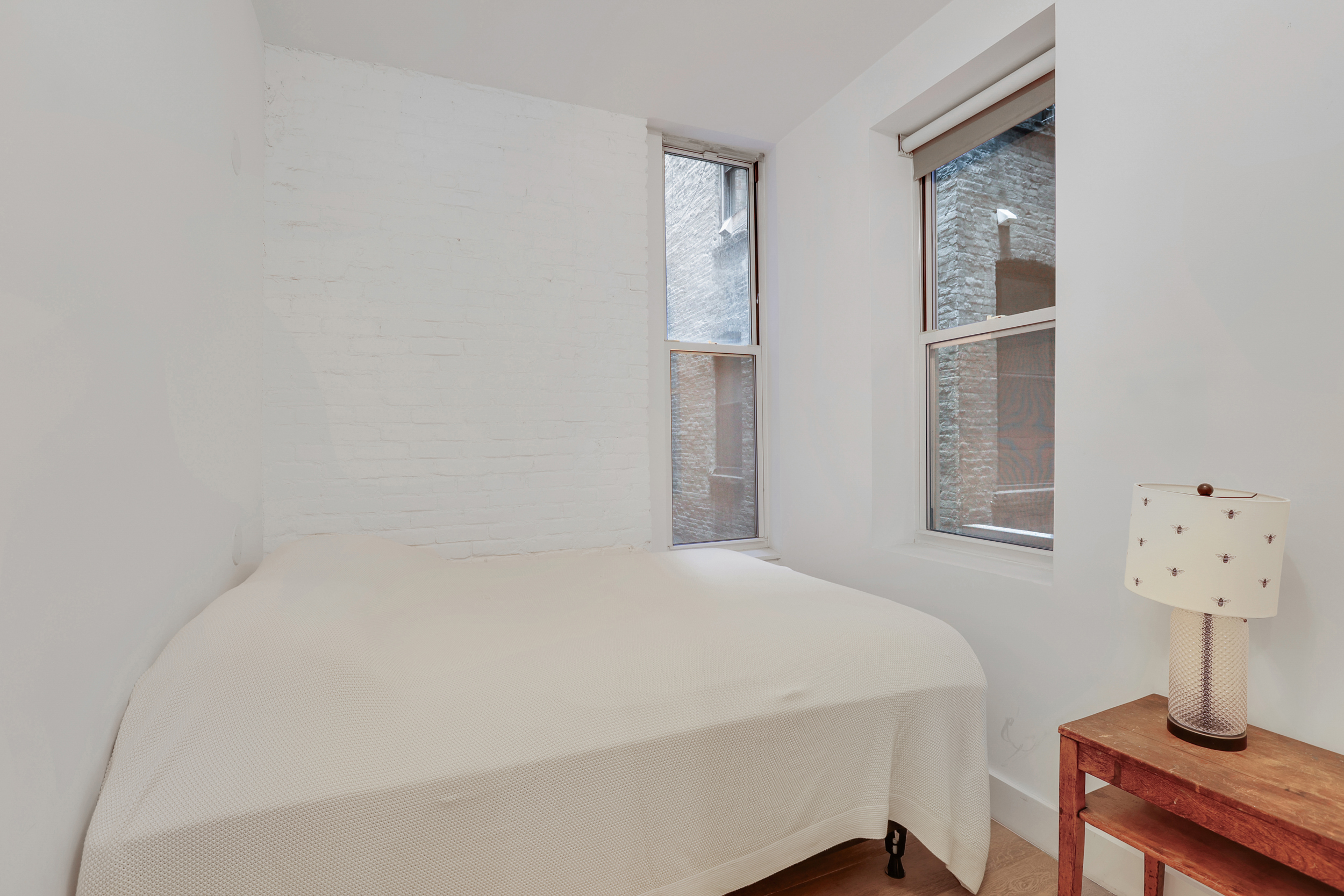 252 East 7th Street, Unit 7/8 Manhattan, NY 10009 - Photo 9 of 13 a large bed in a white room