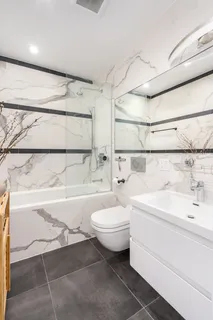 a bathroom with a sink a toilet and bathtub