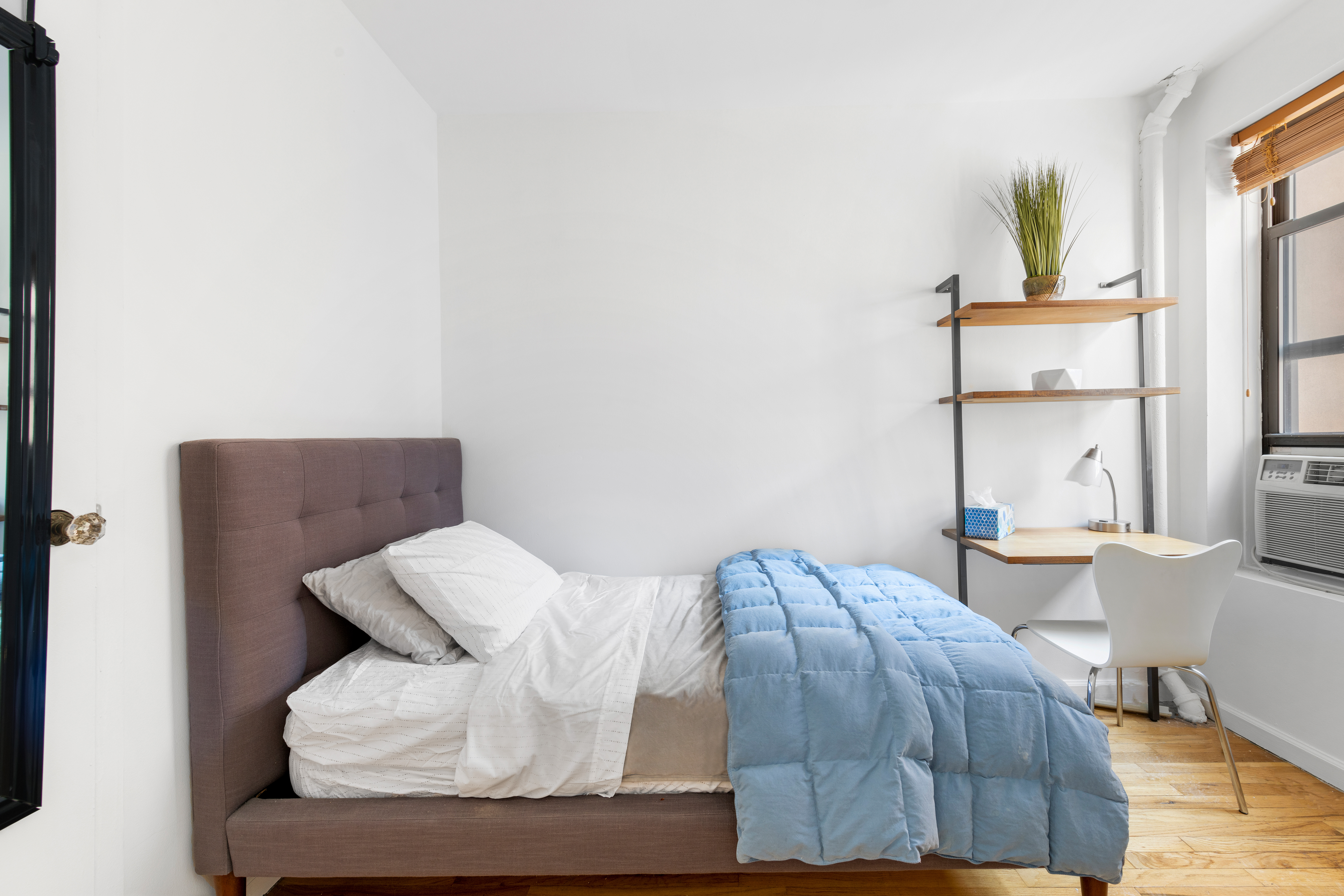 321 East 12th Street, Unit 24 Manhattan, NY 10003 - Photo 6 of 8 a bedroom with a bed and window