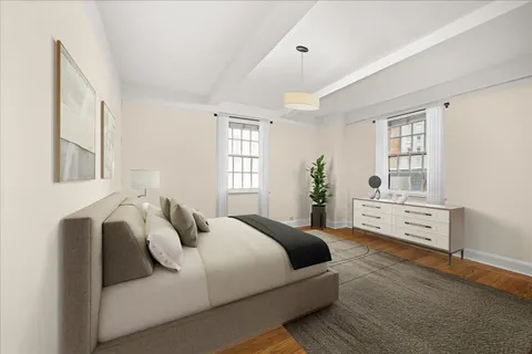 a bedroom with bed and windows