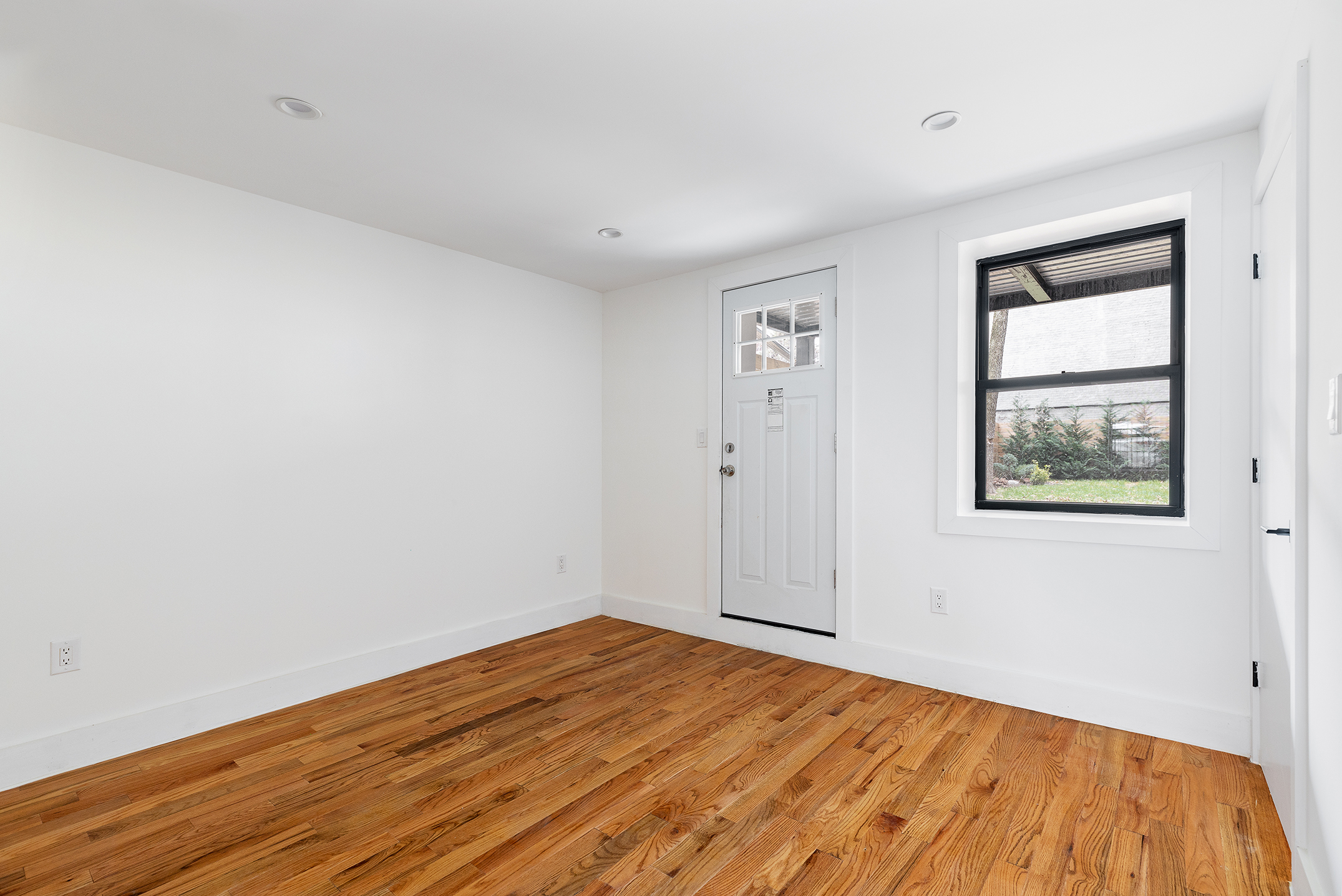 59 Irving Place, Unit 1 Brooklyn, NY 11238 - Photo 3 of 6 a view of empty room with wooden floor and fan