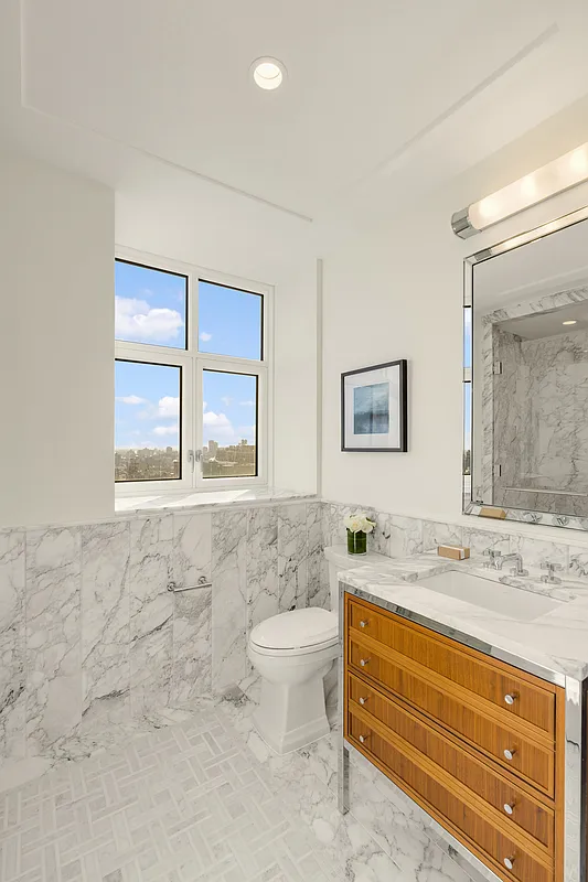 100 Claremont Avenue, Unit 29D Manhattan, NY 10027 - Photo 4 of 9 a bathroom with a toilet sink and mirror