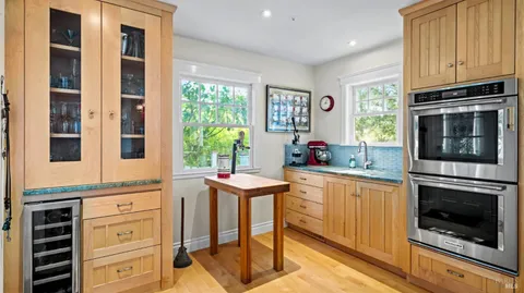 a kitchen with stainless steel appliances granite countertop a stove and cabinets