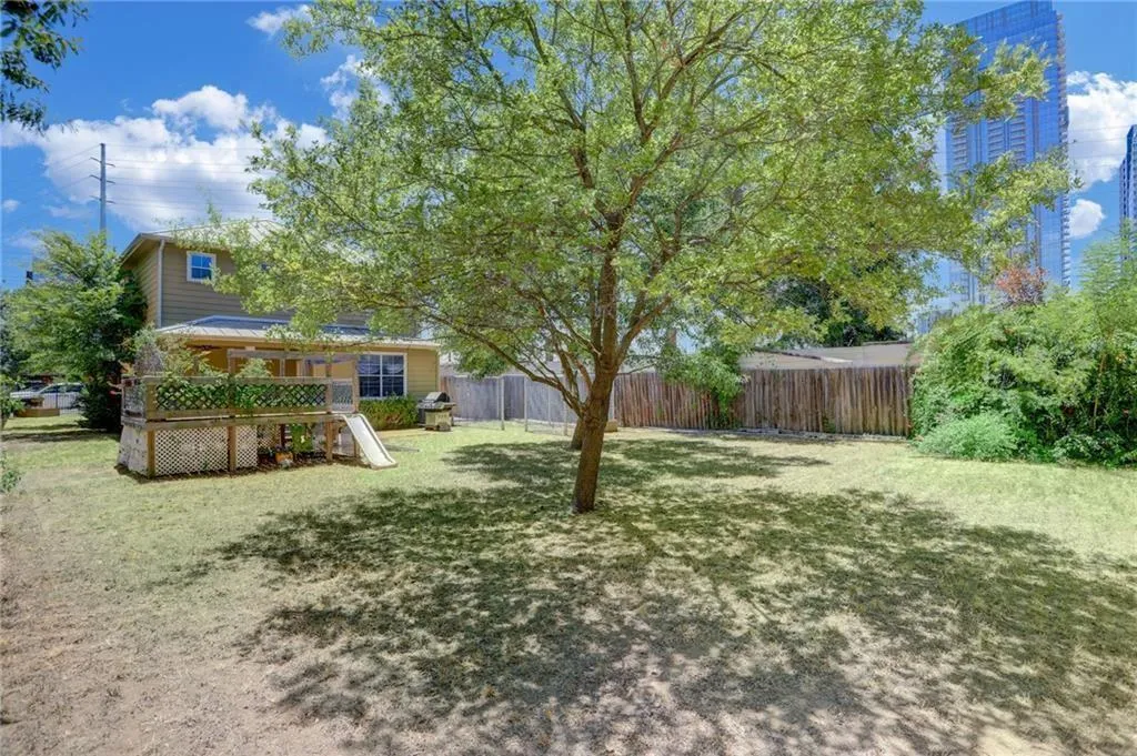 a view of a house with yard and sitting area