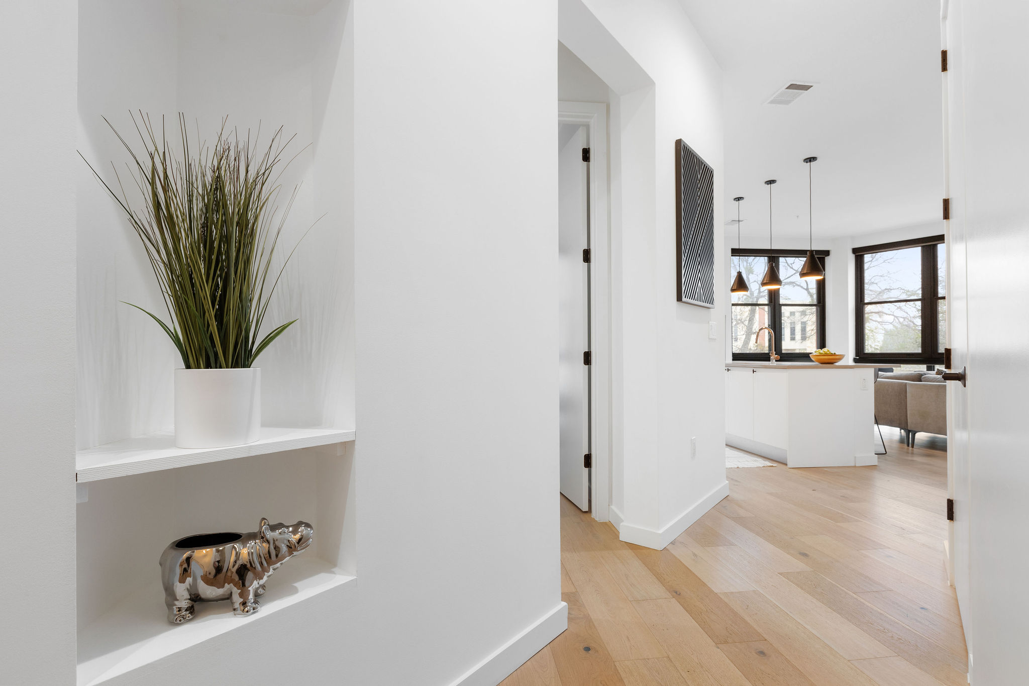 800 Embassy Drive, Unit 236 Austin, TX 78702 - Photo 29 of 50 a view of a hallway and a livingroom with wooden floor