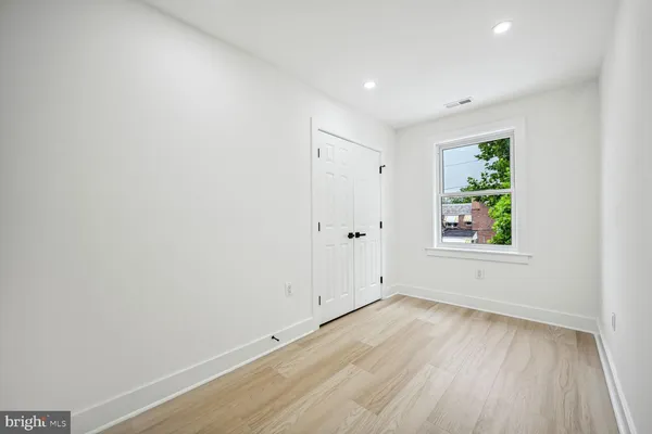 a view of room with window and hardwood floor