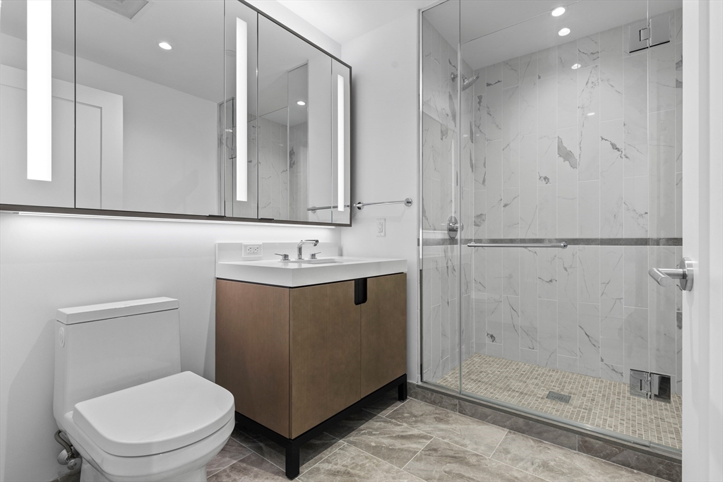 380 Harrison Avenue, Unit 1005 Boston, MA 02118 - Photo 5 of 14 a bathroom with a sink a toilet and shower