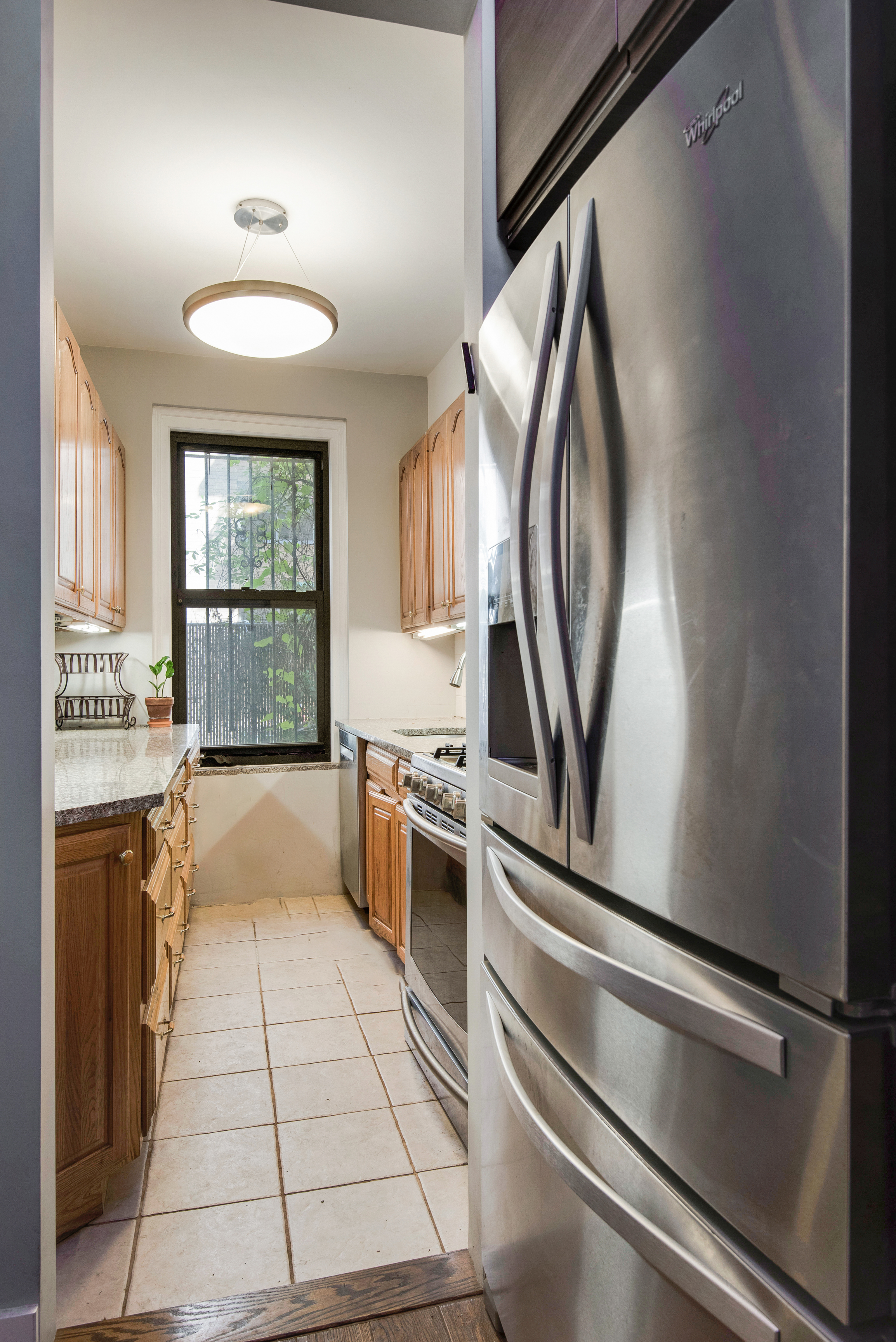 41 West 96th Street, Unit 1B Manhattan, NY 10025 - Photo 13 of 24 a kitchen with stainless steel appliances granite countertop a refrigerator and a stove