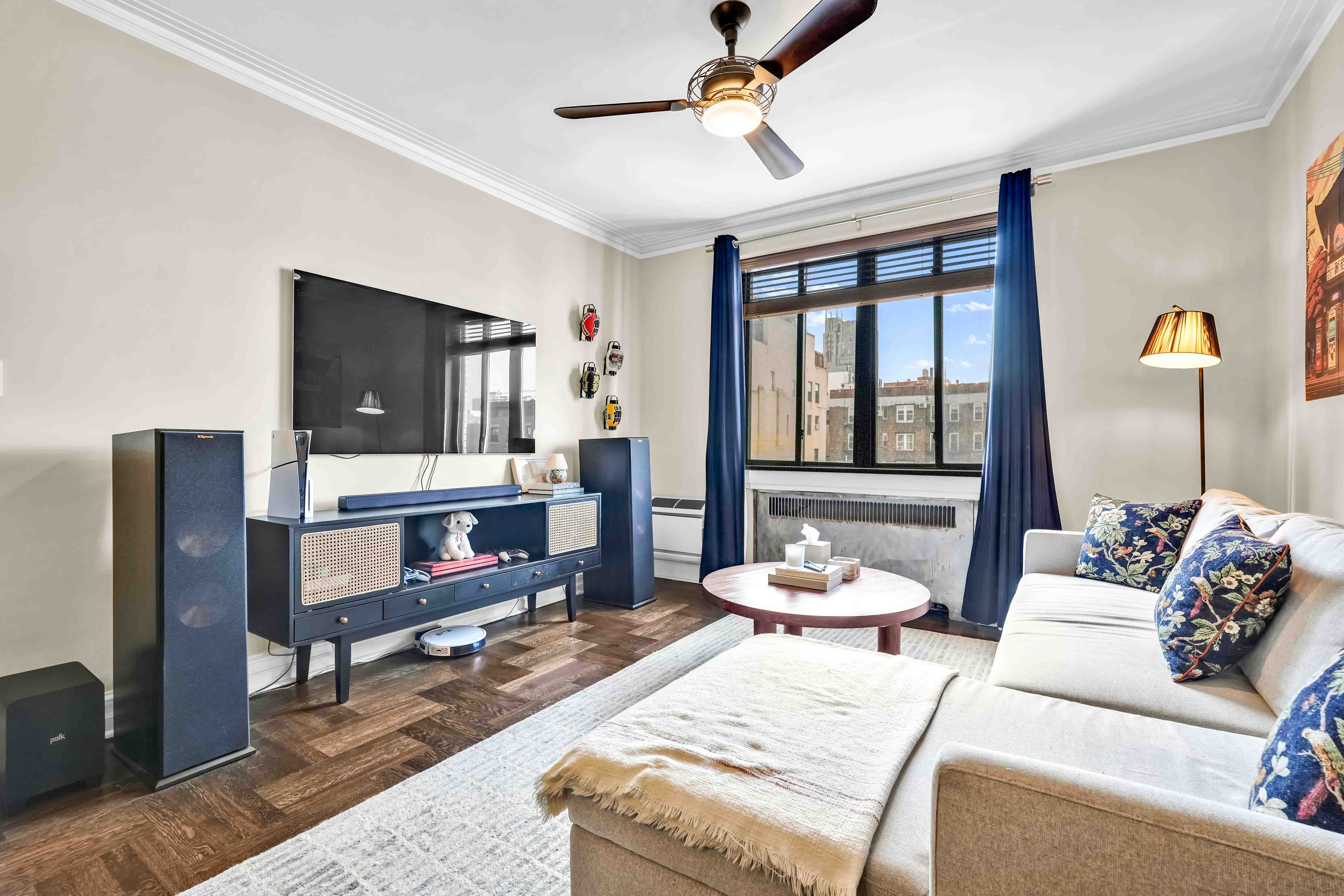 255 West 23rd Street, Unit 5GW Manhattan, NY 10011 - Photo 4 of 35 a living room with furniture and a flat screen tv