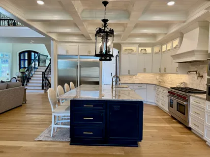a kitchen with stainless steel appliances granite countertop a stove and a wooden floor