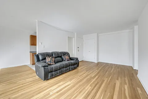 a living room with a couch and a wooden floor