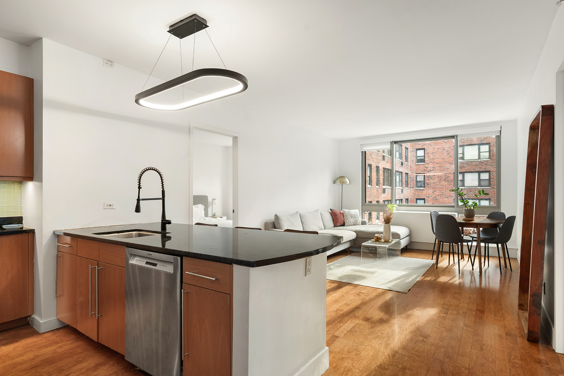 a kitchen with a sink and living room filled with furniture