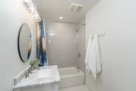 a bathroom with a tub and shower