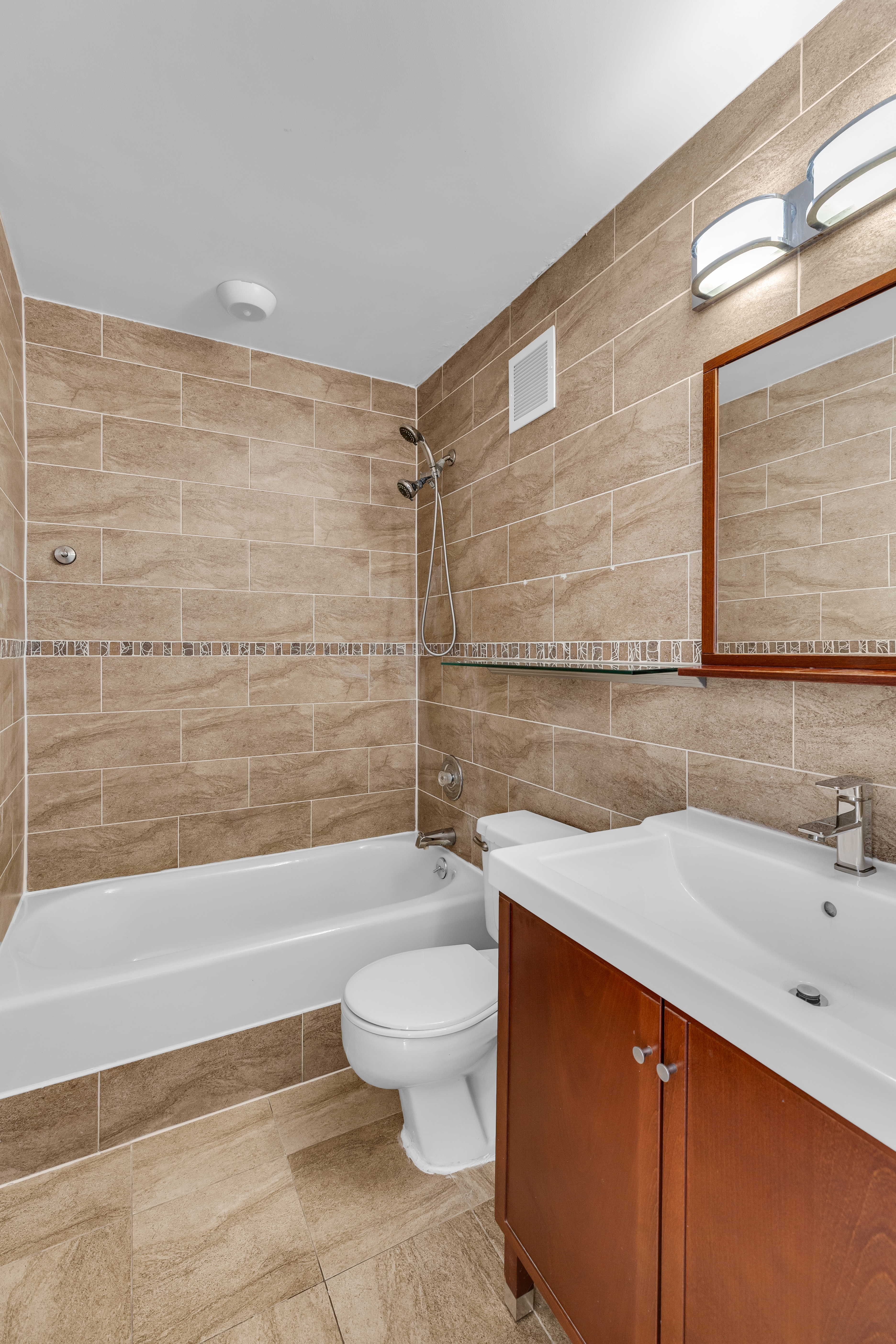 25-40 Shore Boulevard, Unit 2F Queens, NY 11102 - Photo 12 of 31 a bathroom with a sink a toilet and shower