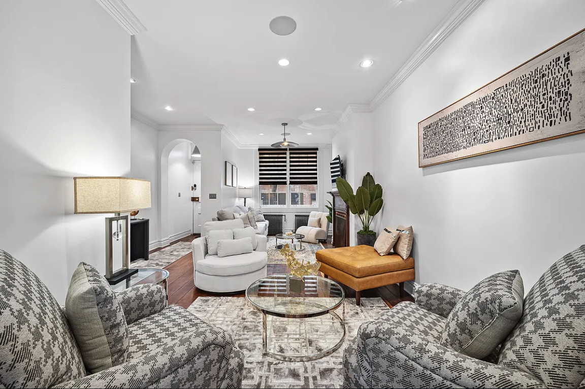 a living room with furniture and a mirror