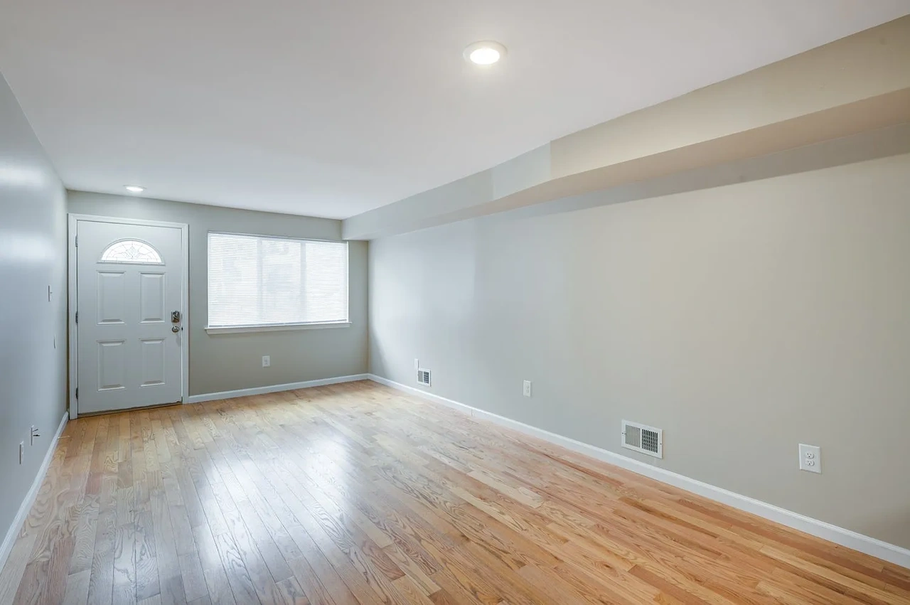 2817 Batchelder Street, Unit 1 Brooklyn, NY 11235 - Photo 2 of 4 a view of an empty room with wooden floor and a window