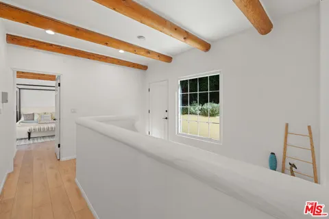 a spacious bedroom with a bed and chair