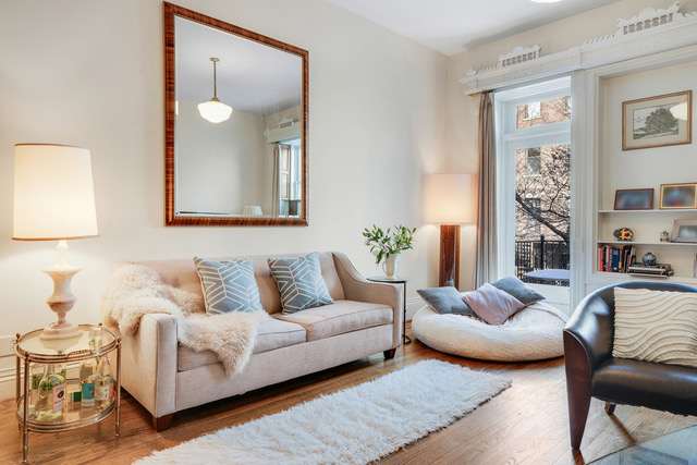 347 West 121st Street Manhattan, NY 10027 - Photo 2 of 16 a living room with furniture and a large mirror next to a window
