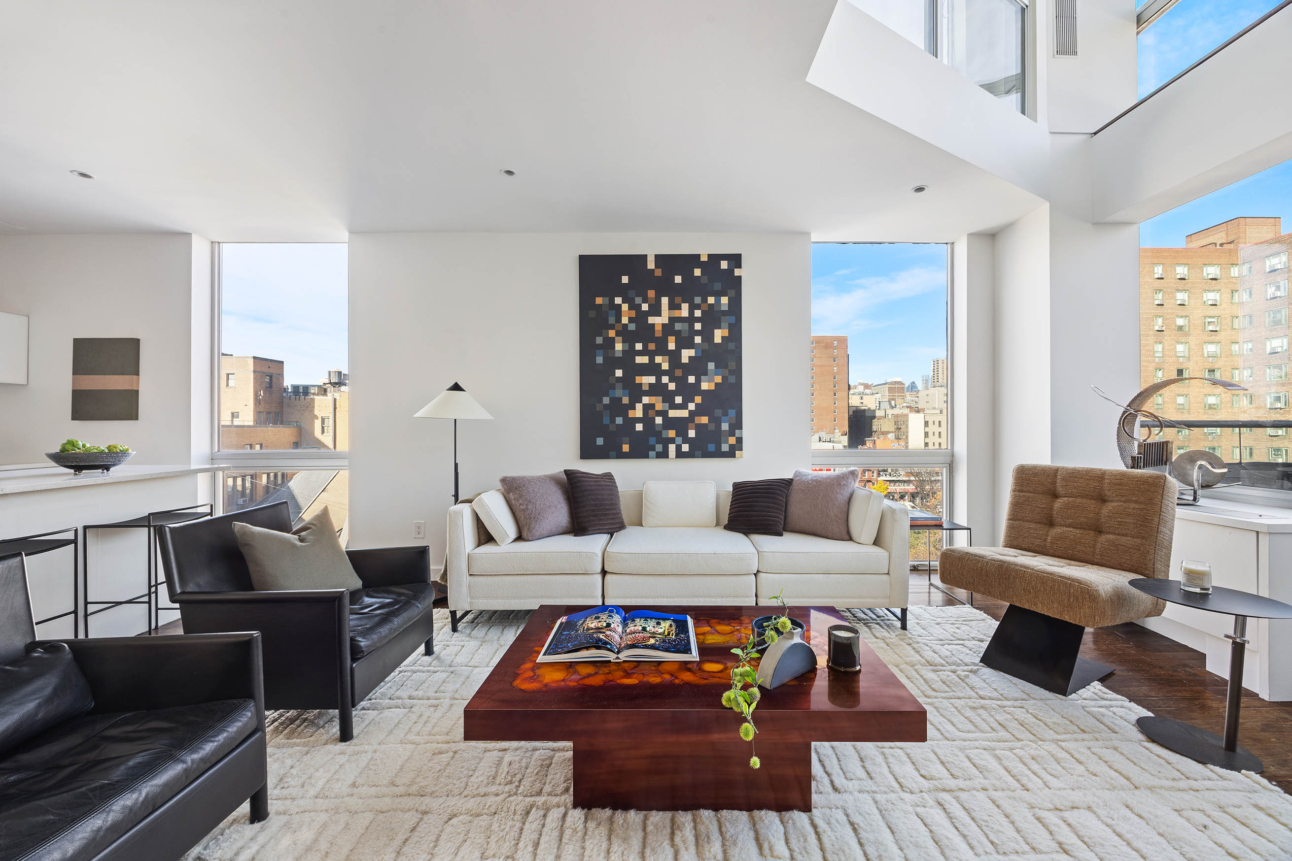425 East 13th Street, Unit PHFG Manhattan, NY 10009 - Photo 2 of 31 a living room with furniture and a large window