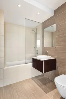 a bathroom with a bathtub shower sink and toilet