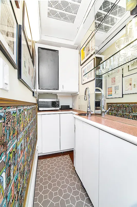 936 5th Avenue, Unit MOC2 Manhattan, NY 10021 - Photo 8 of 14 a kitchen with a sink a stove and cabinets