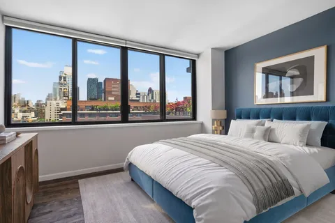 a bedroom with a large bed and a large window