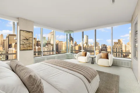 a bedroom with a large bed and large window