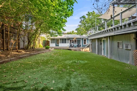 a view of a house with pool and sitting area
