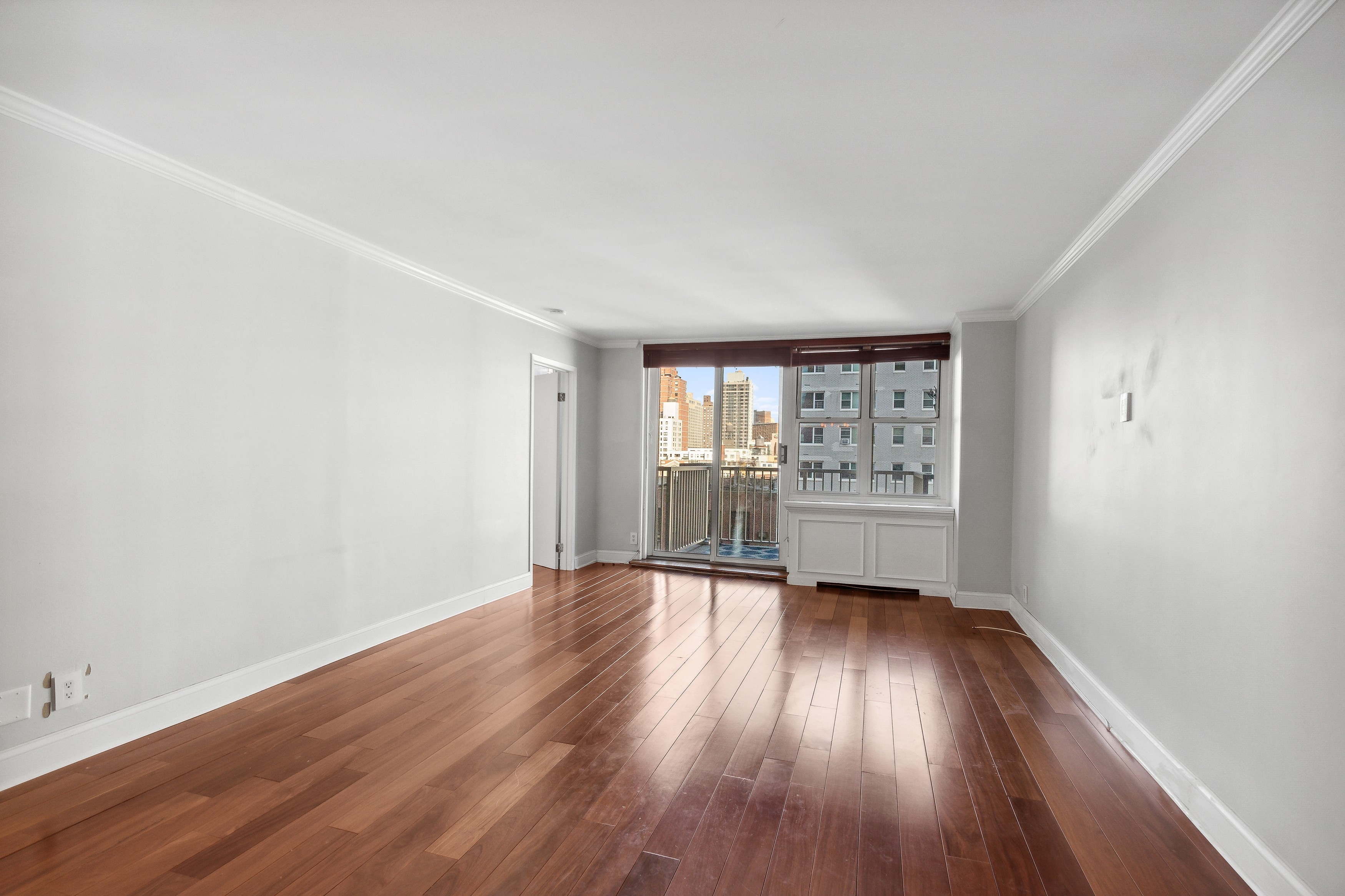 444 East 86th Street, Unit 11B Manhattan, NY 10028 - Photo 2 of 18 wooden floor in an empty room with a window