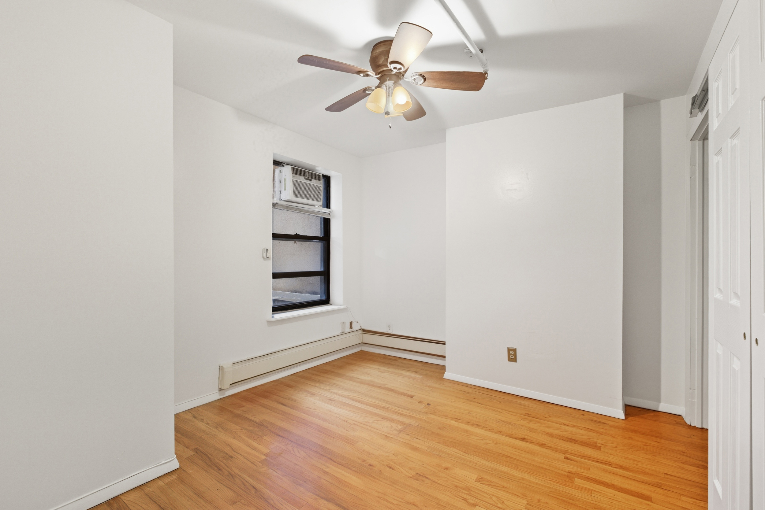 420 East 117th Street, Unit 1 Manhattan, NY 10035 - Photo 7 of 9 a view of empty room with wooden floor
