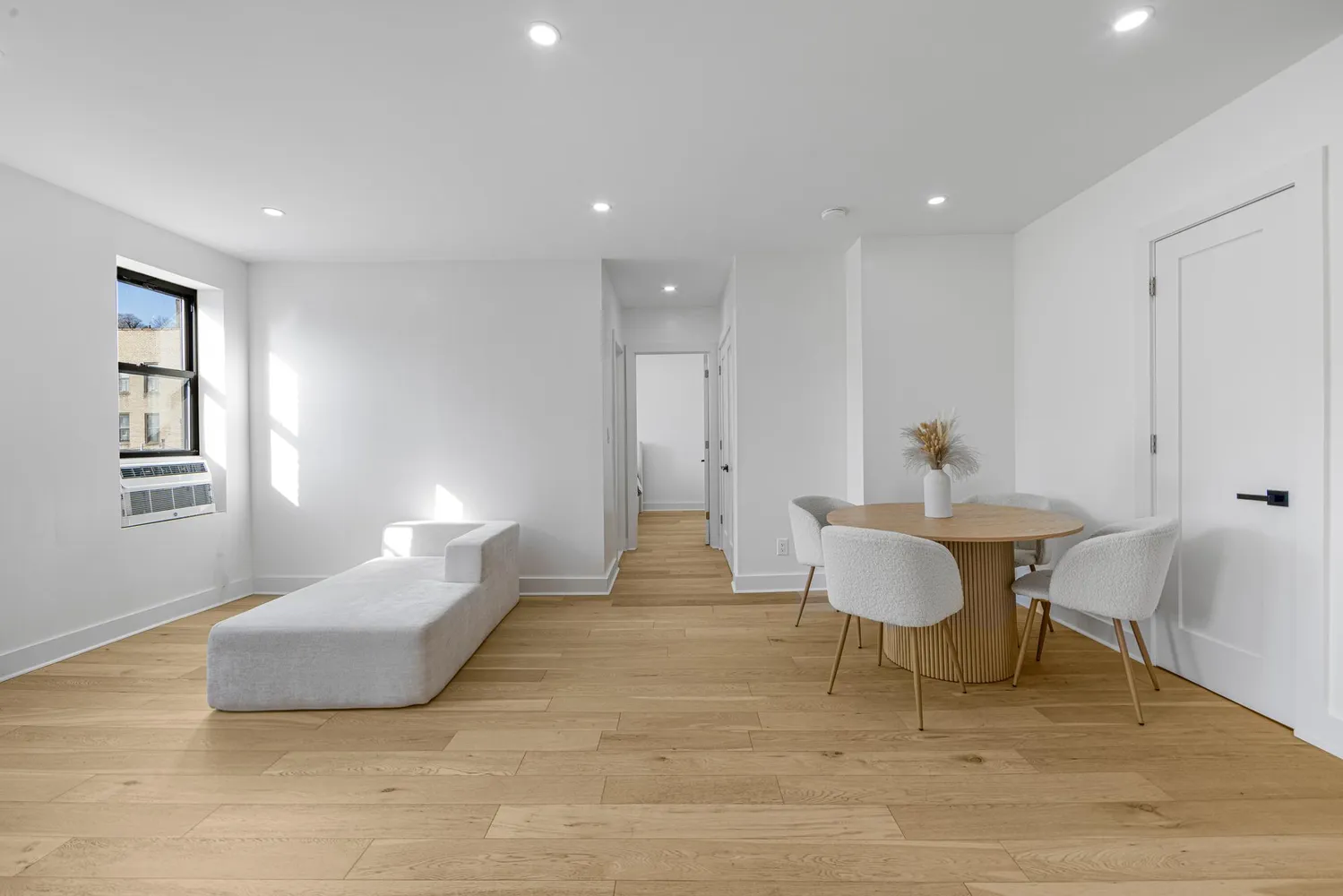 a living room with furniture and a wooden floor