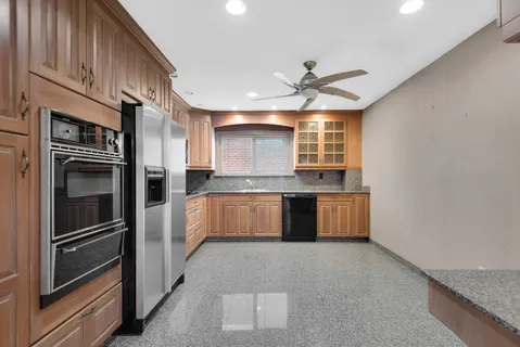 a view of a kitchen with a sink and stainless steel appliances