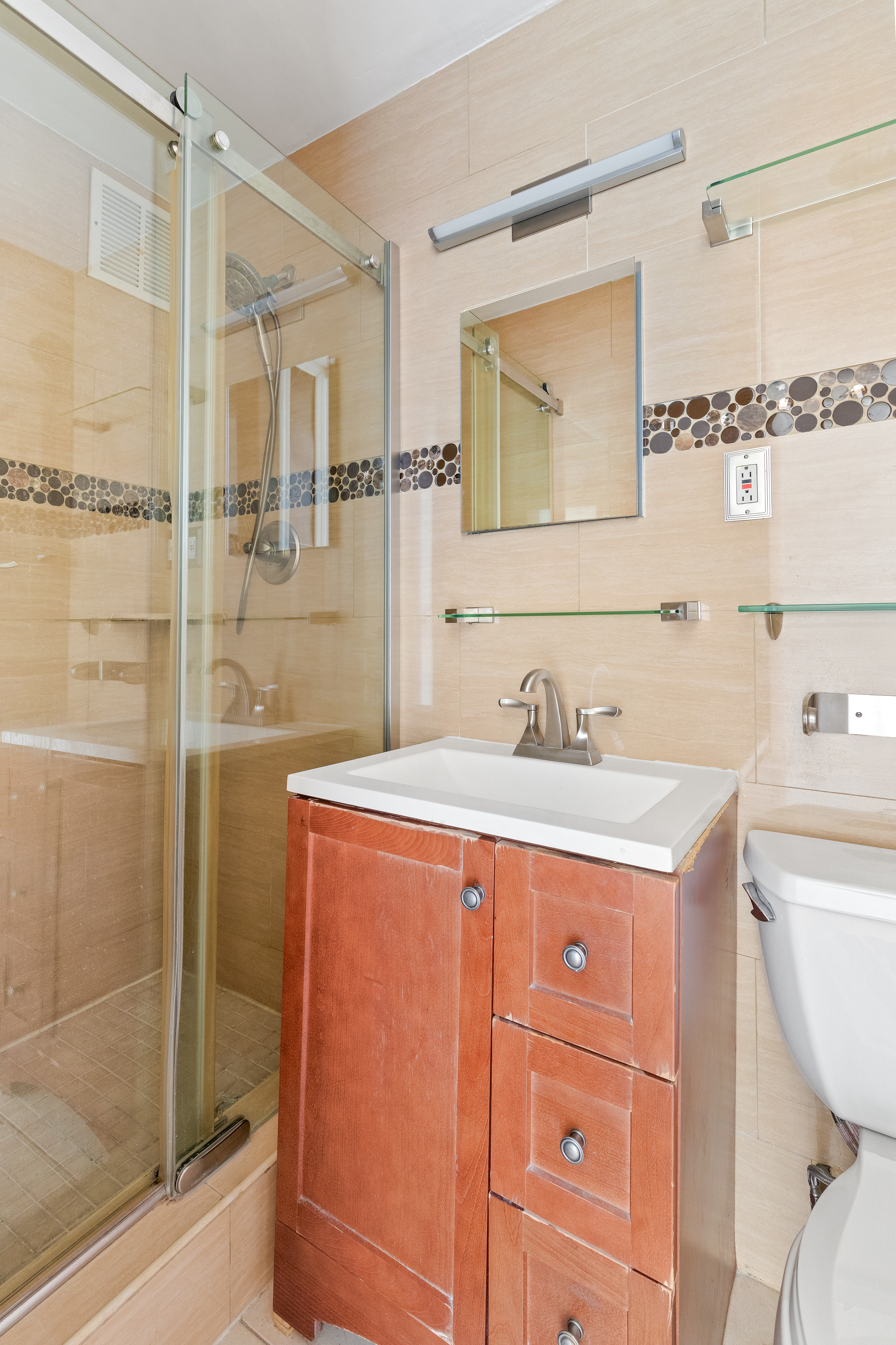 195 Willoughby Avenue, Unit 1612 Brooklyn, NY 11205 - Photo 8 of 10 a bathroom with a granite countertop sink toilet and shower