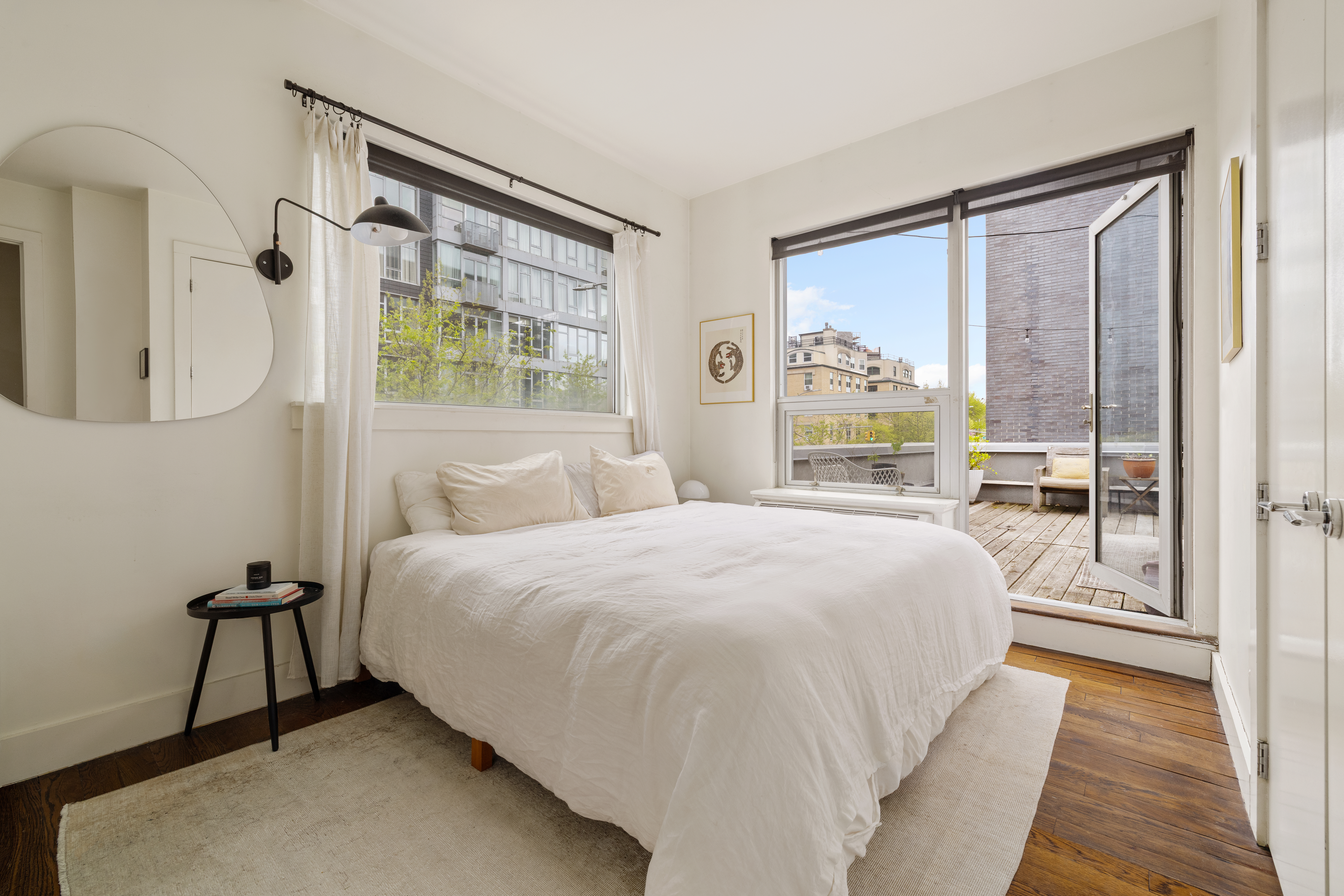 15 Roebling Street, Unit 2A Brooklyn, NY 11211 - Photo 4 of 8 a bedroom with a bed and a large window